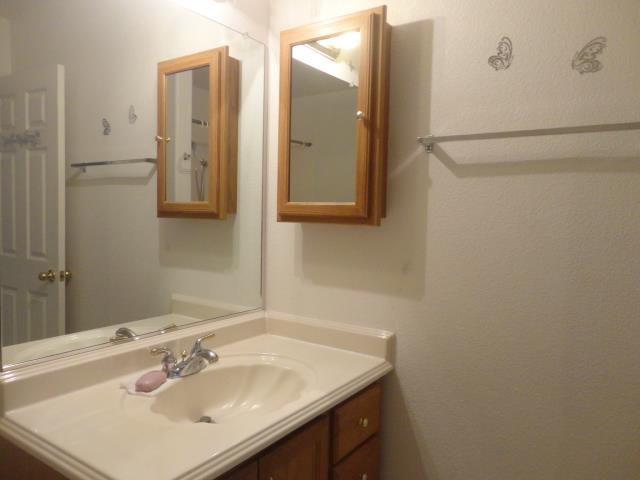 521 W West 9th Street Merced, CA 95341 - Photo 16 of 21 a bathroom with a sink and a mirror