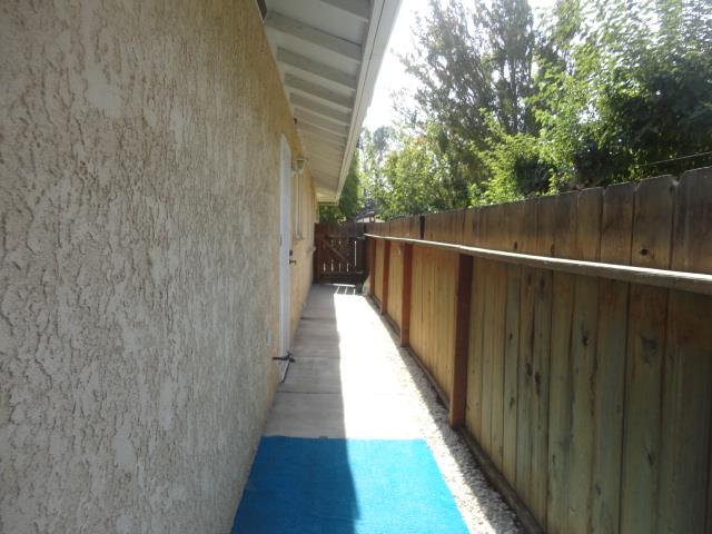 521 W West 9th Street Merced, CA 95341 - Photo 20 of 21 a view of balcony with wooden floor and fence