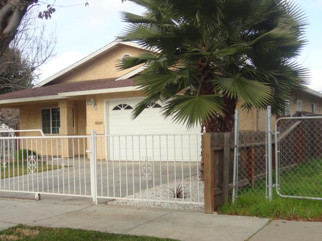 521 W West 9th Street Merced, CA 95341 - Photo 3 of 21 a front view of a house with a garden