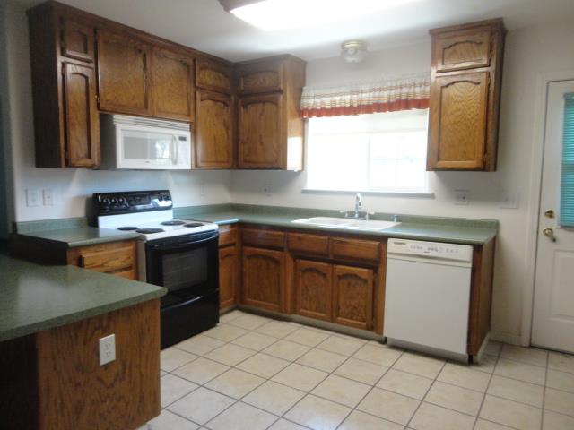 521 W West 9th Street Merced, CA 95341 - Photo 7 of 21 a kitchen with stainless steel appliances granite countertop a sink stove and refrigerator