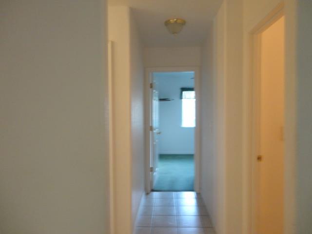 521 W West 9th Street Merced, CA 95341 - Photo 10 of 21 a view of a hallway with wooden floor