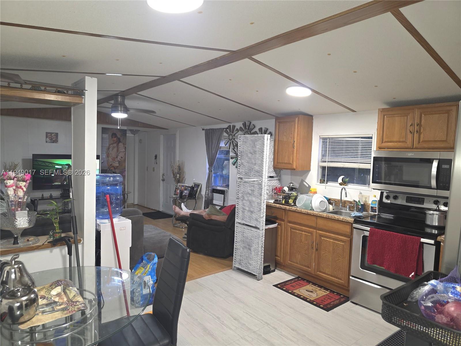 575 Vero Avenue Clewiston, FL 33440 - Photo 11 of 32 a kitchen with stainless steel appliances kitchen island granite countertop a stove refrigerator and cabinets
