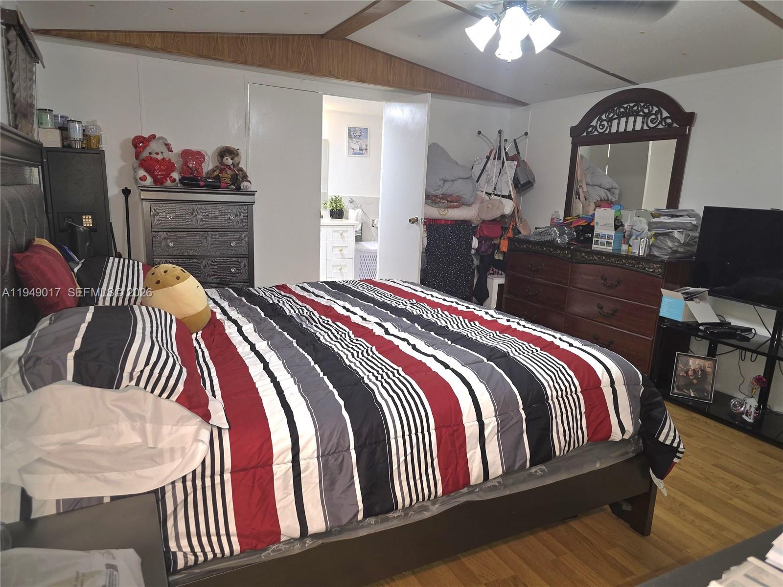 575 Vero Avenue Clewiston, FL 33440 - Photo 13 of 32 a bedroom with a bed and a dresser in it