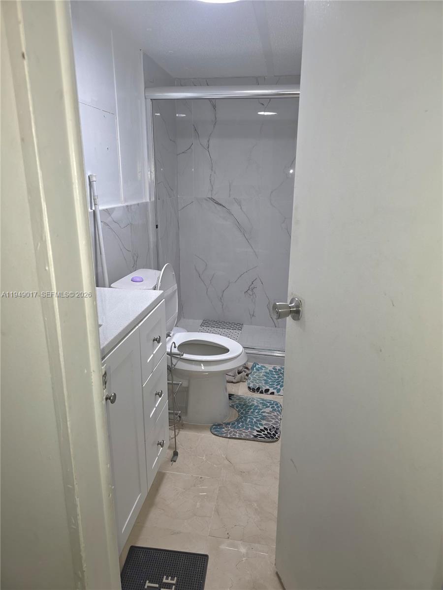 575 Vero Avenue Clewiston, FL 33440 - Photo 17 of 32 a bathroom with a sink and a toilet