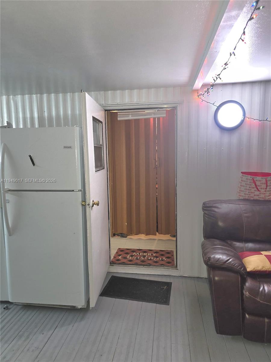 575 Vero Avenue Clewiston, FL 33440 - Photo 19 of 32 a living room with a couch and a stove with wooden floor