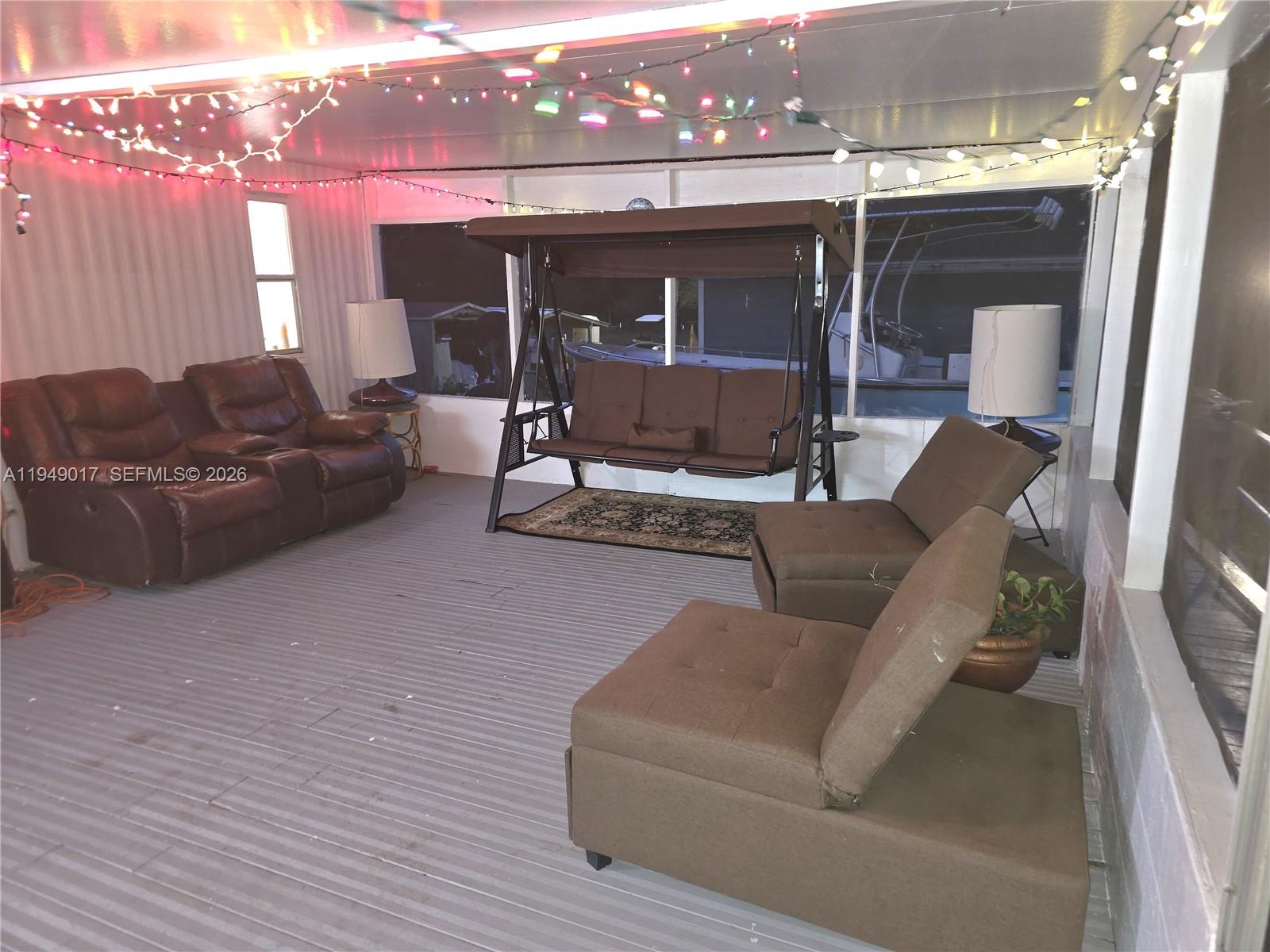 575 Vero Avenue Clewiston, FL 33440 - Photo 20 of 32 a living room with furniture and a fireplace