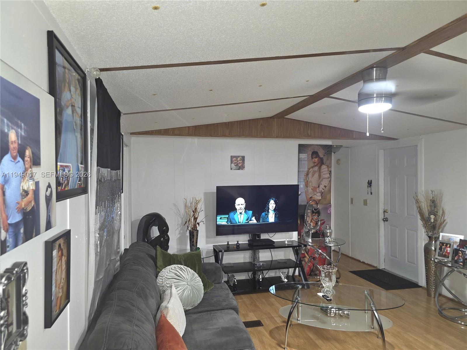 575 Vero Avenue Clewiston, FL 33440 - Photo 26 of 32 a living room with furniture a fireplace and a flat screen tv