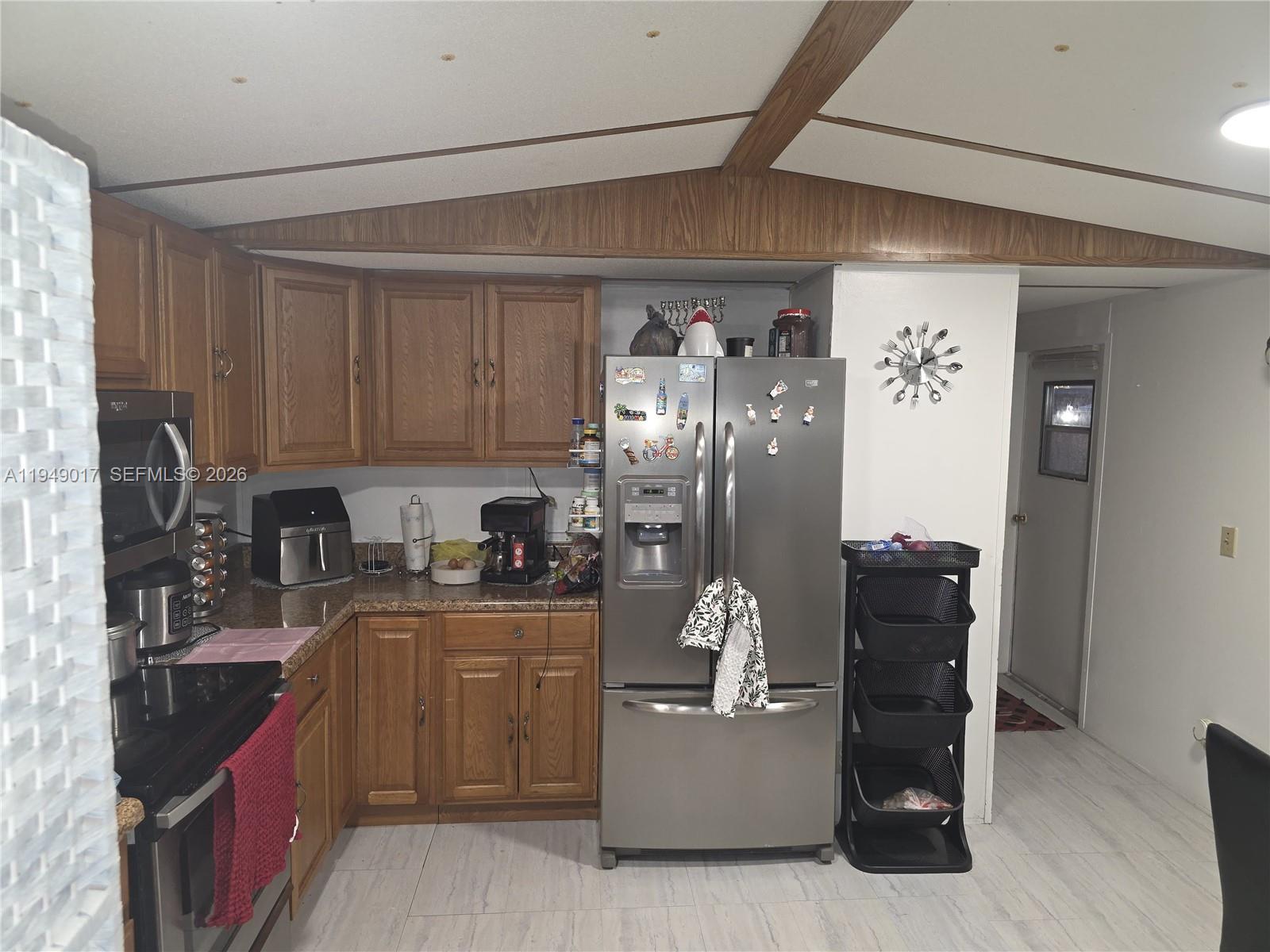 575 Vero Avenue Clewiston, FL 33440 - Photo 28 of 32 a kitchen with stainless steel appliances granite countertop a refrigerator and a stove top oven
