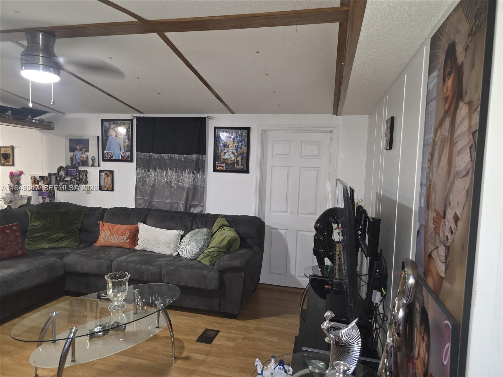 575 Vero Avenue Clewiston, FL 33440 - Photo 30 of 32 a living room with furniture and a flat screen tv