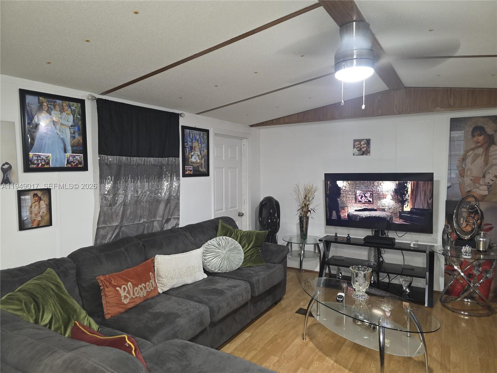 575 Vero Avenue Clewiston, FL 33440 - Photo 31 of 32 a living room with furniture and a flat screen tv