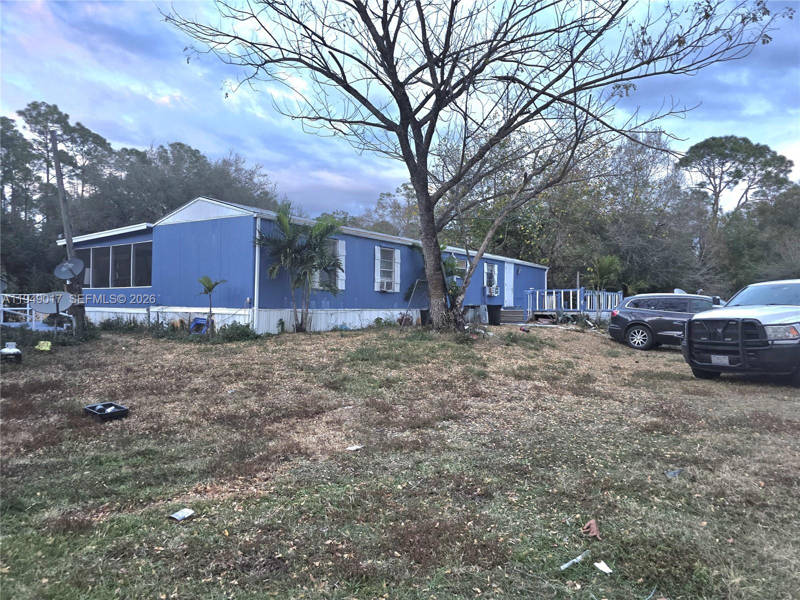 575 Vero Avenue Clewiston, FL 33440 - Photo 9 of 32 a view of a house with a yard and large tree