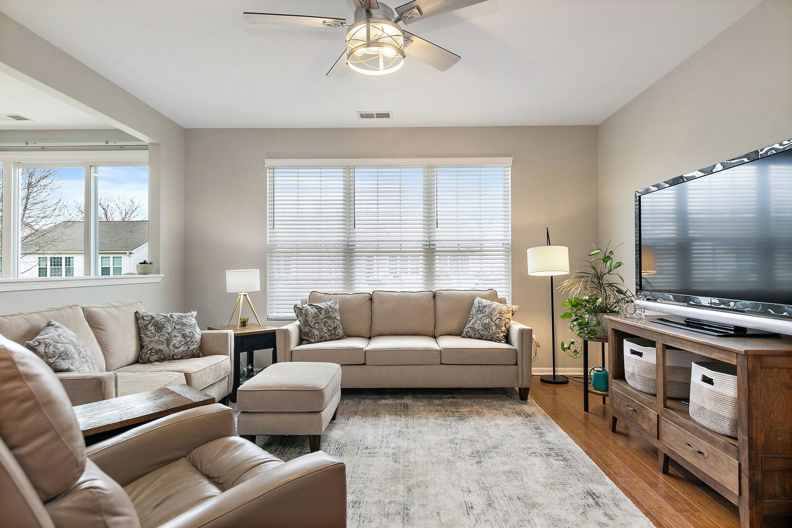 Undisclosed Address Elgin, IL 60124 - Photo 6 of 35 a living room with furniture a large window and a flat screen tv