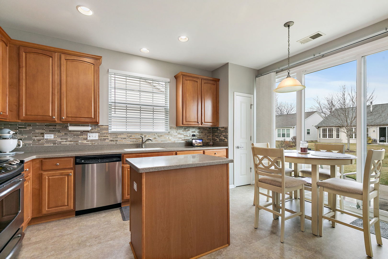 Undisclosed Address Elgin, IL 60124 - Photo 7 of 35 a kitchen with lots of counter top space and dining table