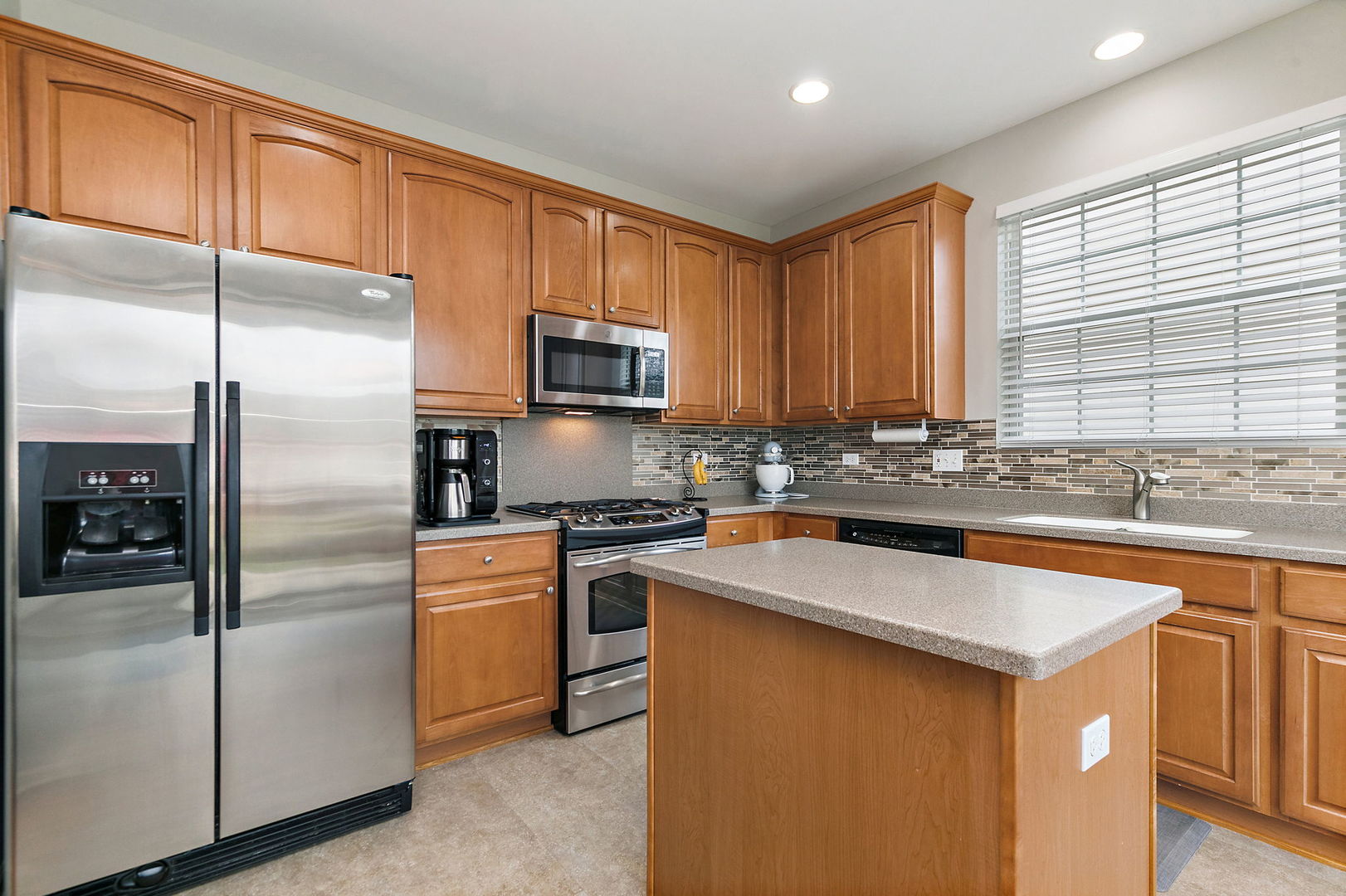 Undisclosed Address Elgin, IL 60124 - Photo 9 of 35 a kitchen with stainless steel appliances granite countertop a refrigerator a sink dishwasher a stove and a refrigerator