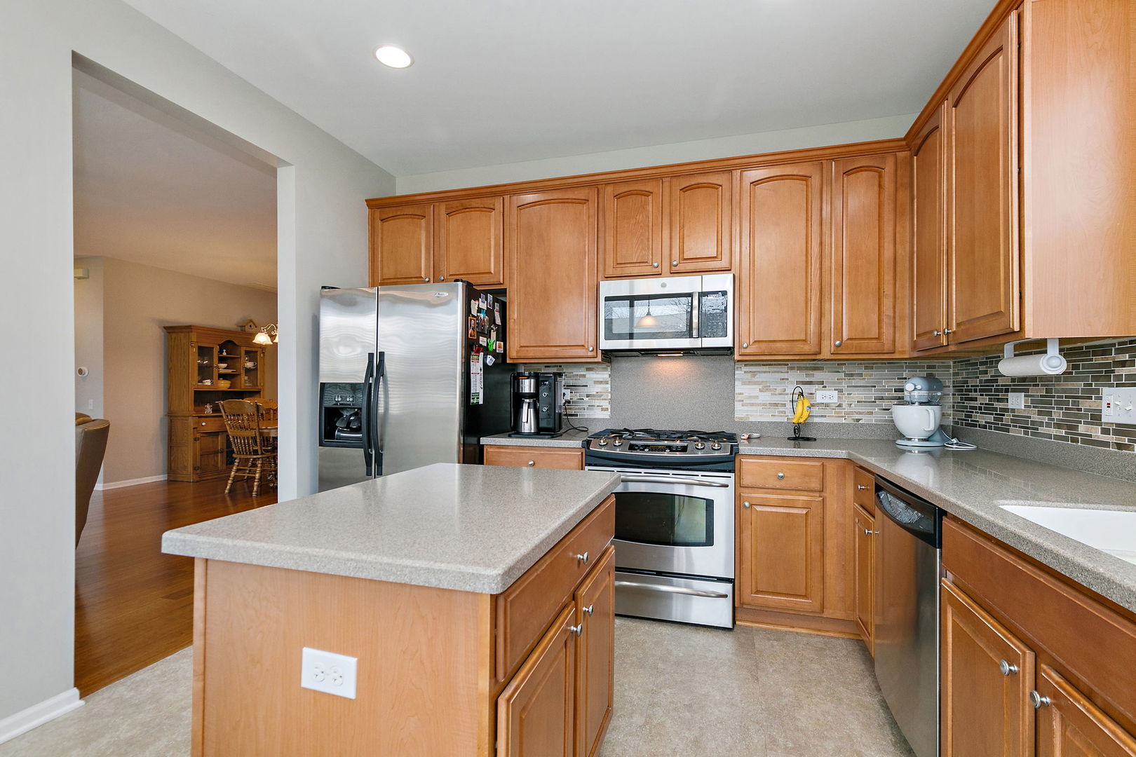 Undisclosed Address Elgin, IL 60124 - Photo 10 of 35 a kitchen with stainless steel appliances granite countertop a refrigerator a stove top oven a sink and dishwasher