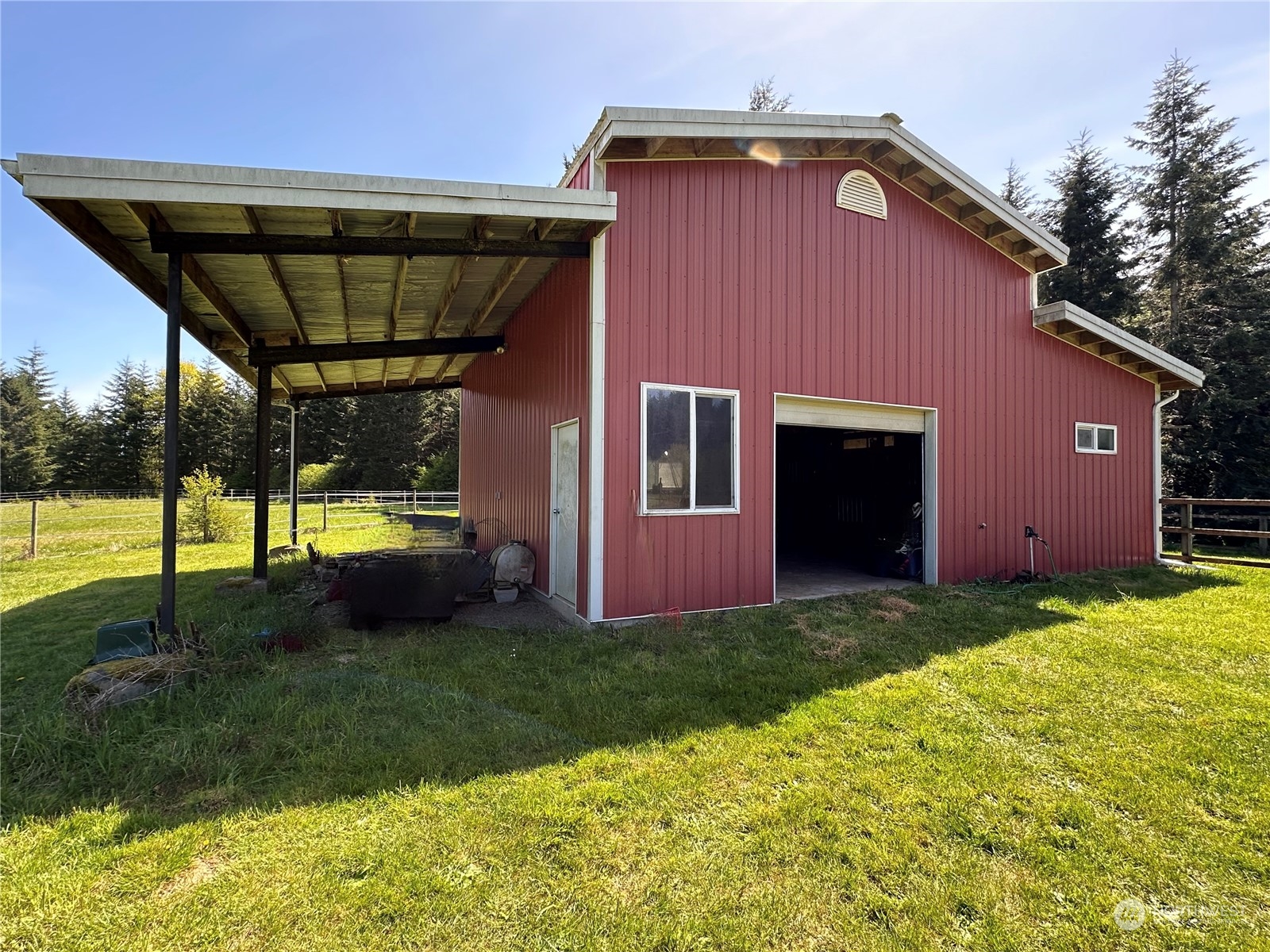 778 Ceres Hill Road, Unit B Chehalis, WA 98532 - Photo 32 of 40 a backyard of a house with table and chairs under an umbrella