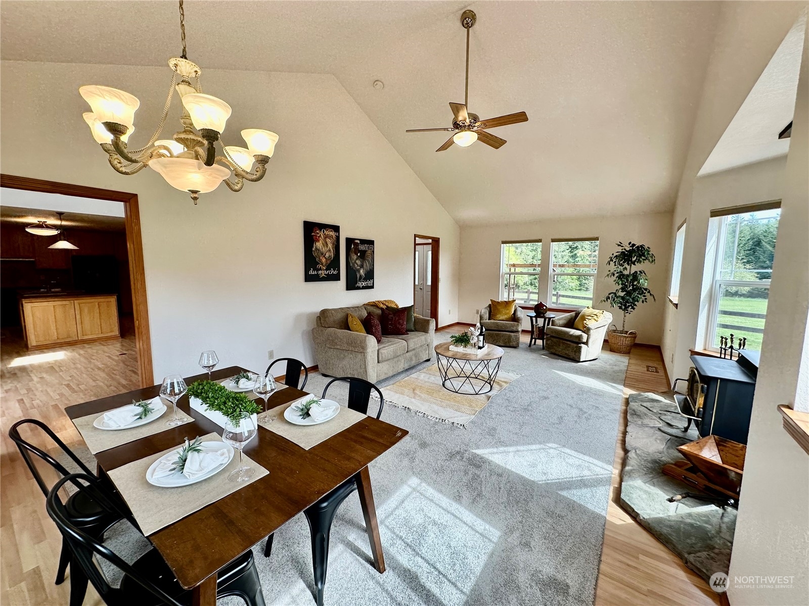 778 Ceres Hill Road, Unit B Chehalis, WA 98532 - Photo 7 of 40 a living room with couches a dining table and a chandelier with wooden floor