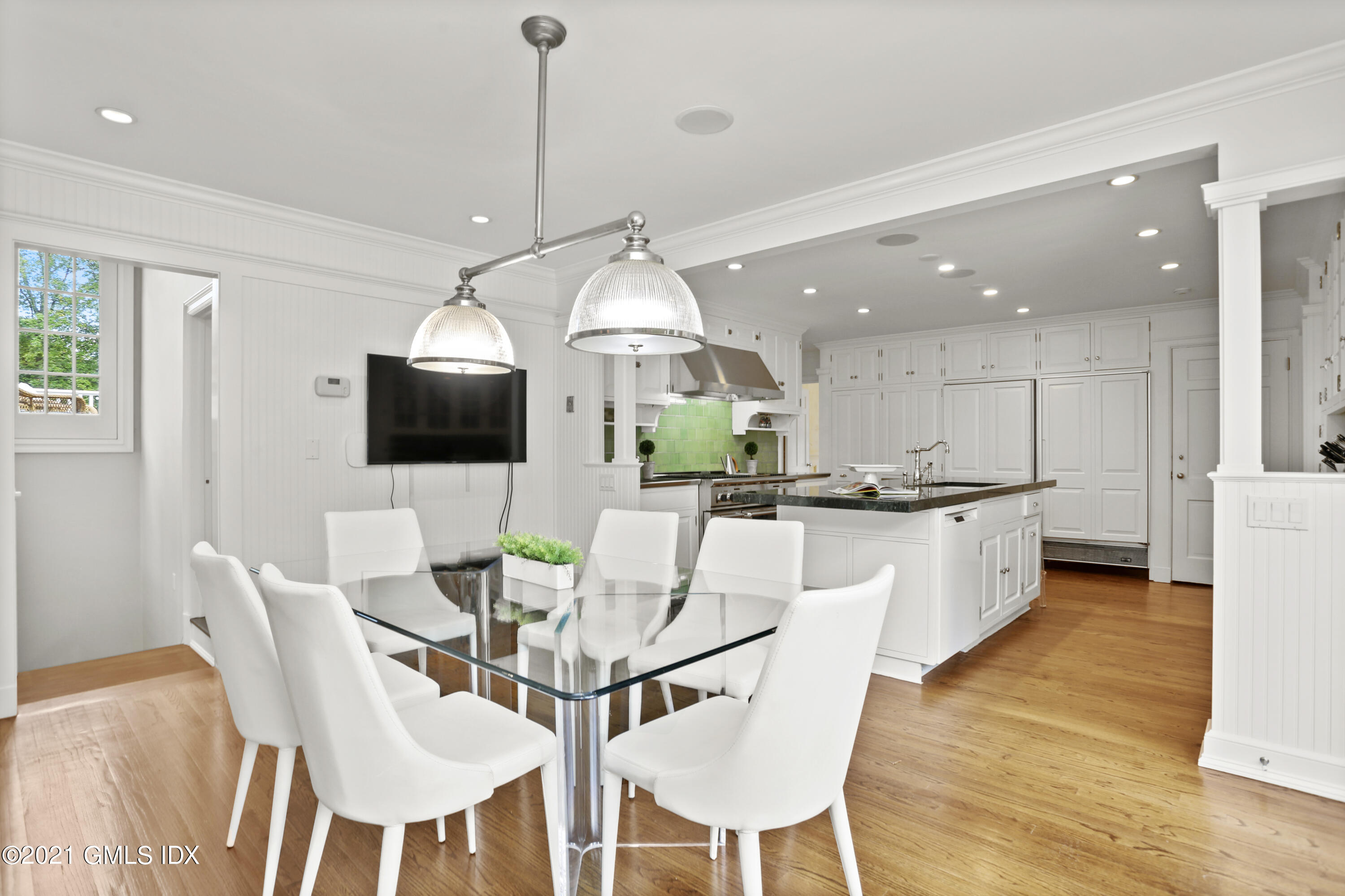5 Tinker Lane Greenwich, CT 06830 - Photo 16 of 44 a kitchen with stainless steel appliances kitchen island granite countertop a kitchen island a stove a table and chairs