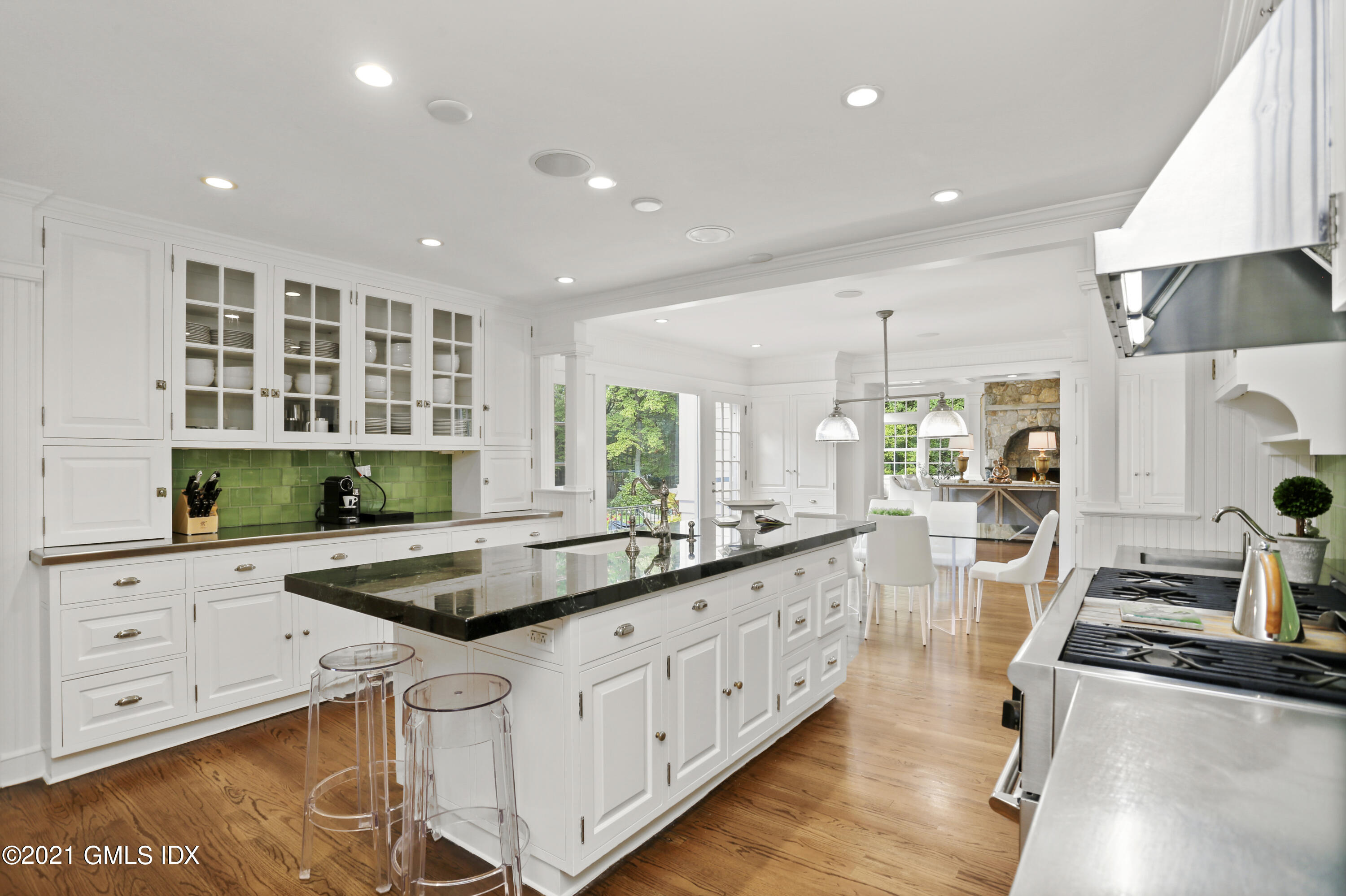 5 Tinker Lane Greenwich, CT 06830 - Photo 19 of 44 a kitchen with sink stove and white cabinets with wooden floor
