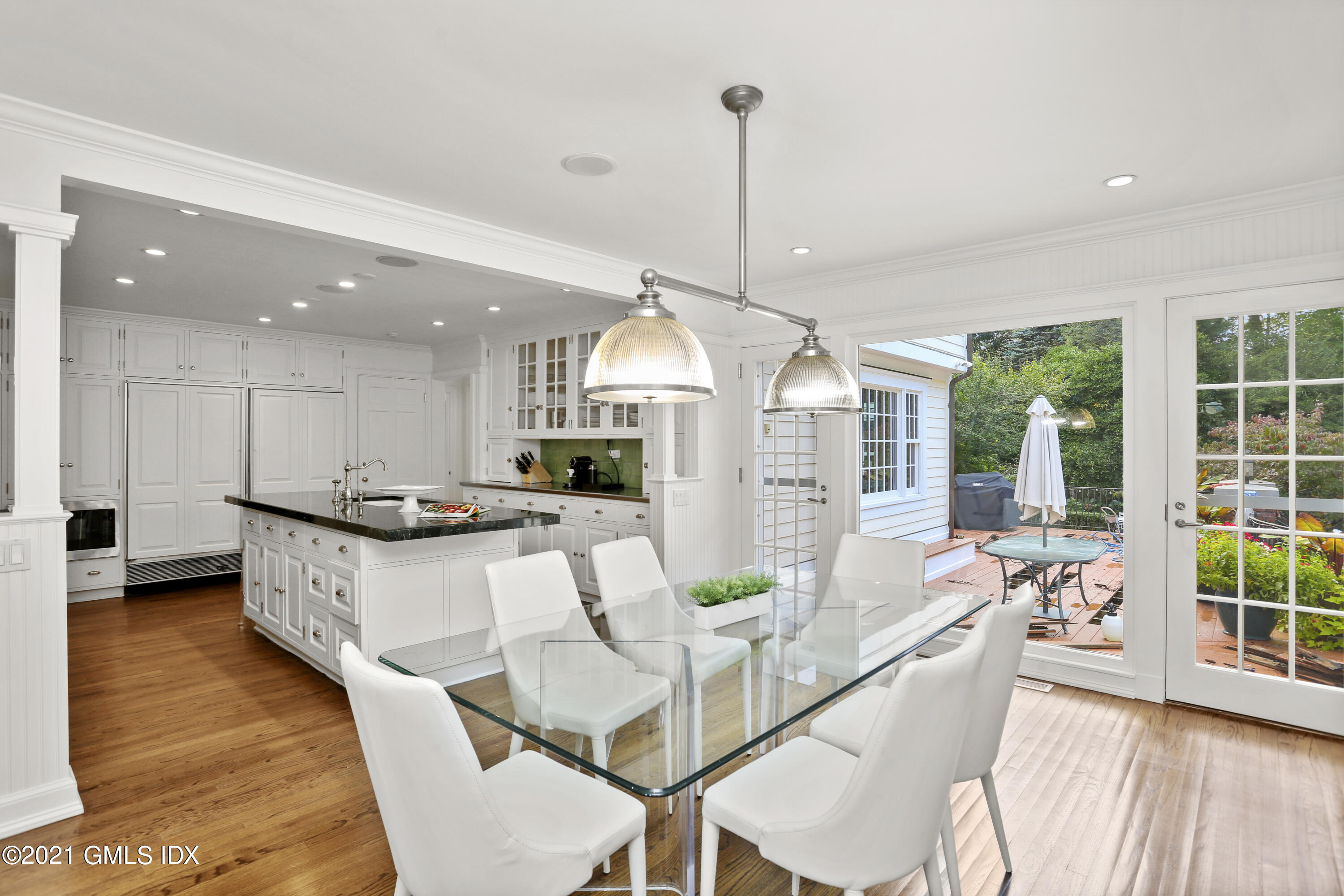 5 Tinker Lane Greenwich, CT 06830 - Photo 20 of 44 a large kitchen with kitchen island a large counter top space a sink stainless steel appliances and windows