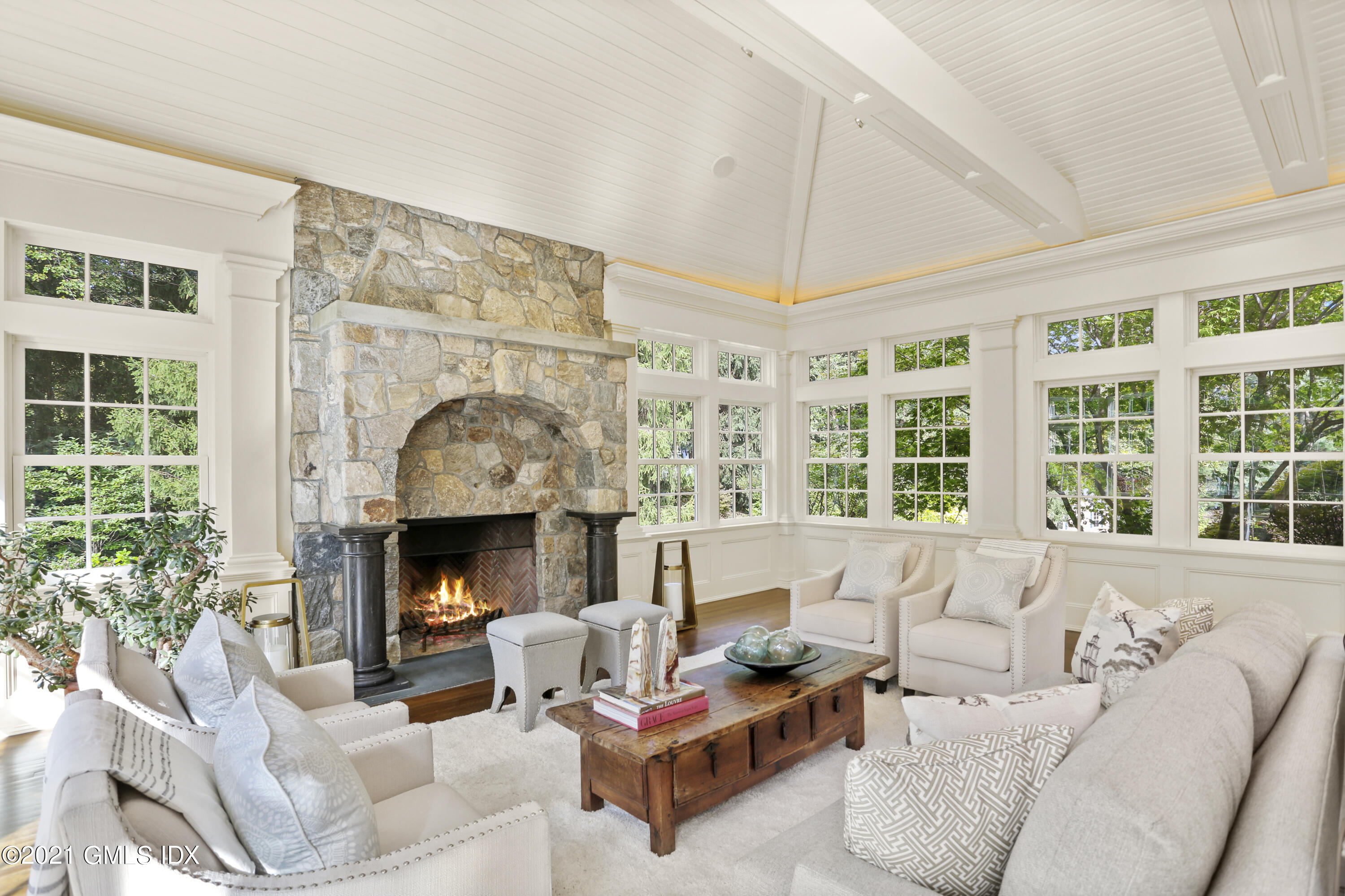5 Tinker Lane Greenwich, CT 06830 - Photo 23 of 44 a living room with furniture a large window and a fireplace