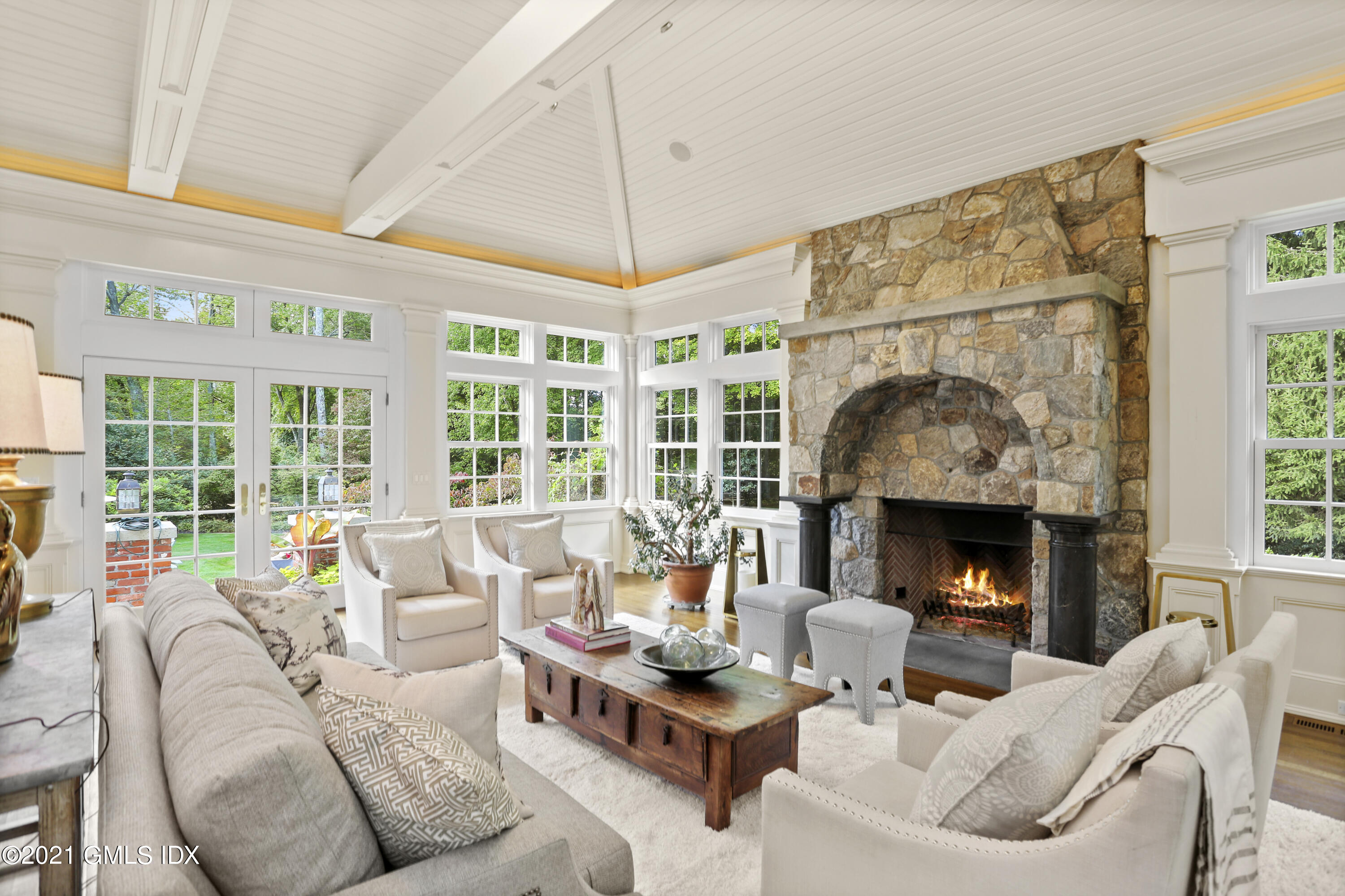 5 Tinker Lane Greenwich, CT 06830 - Photo 24 of 44 a living room with furniture a fireplace and a large window