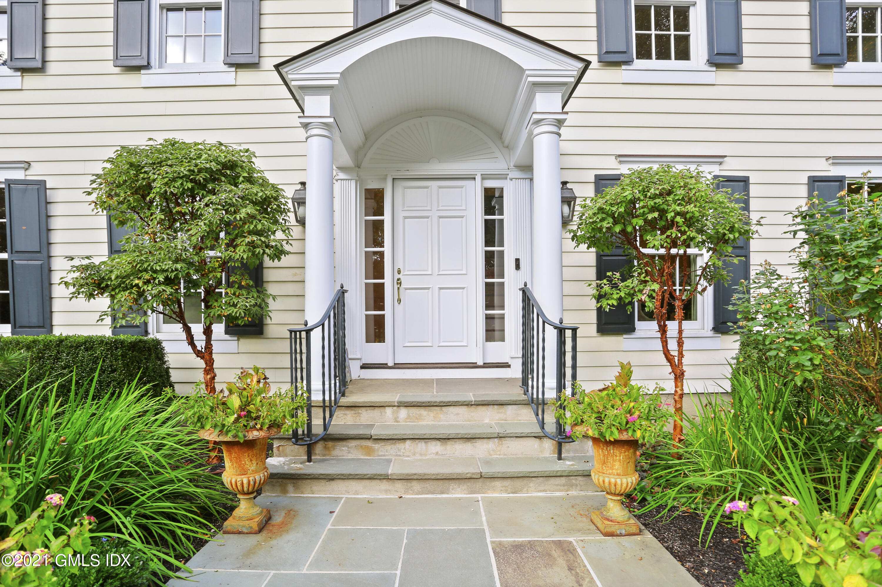 5 Tinker Lane Greenwich, CT 06830 - Photo 35 of 44 a front view of a house with a yard