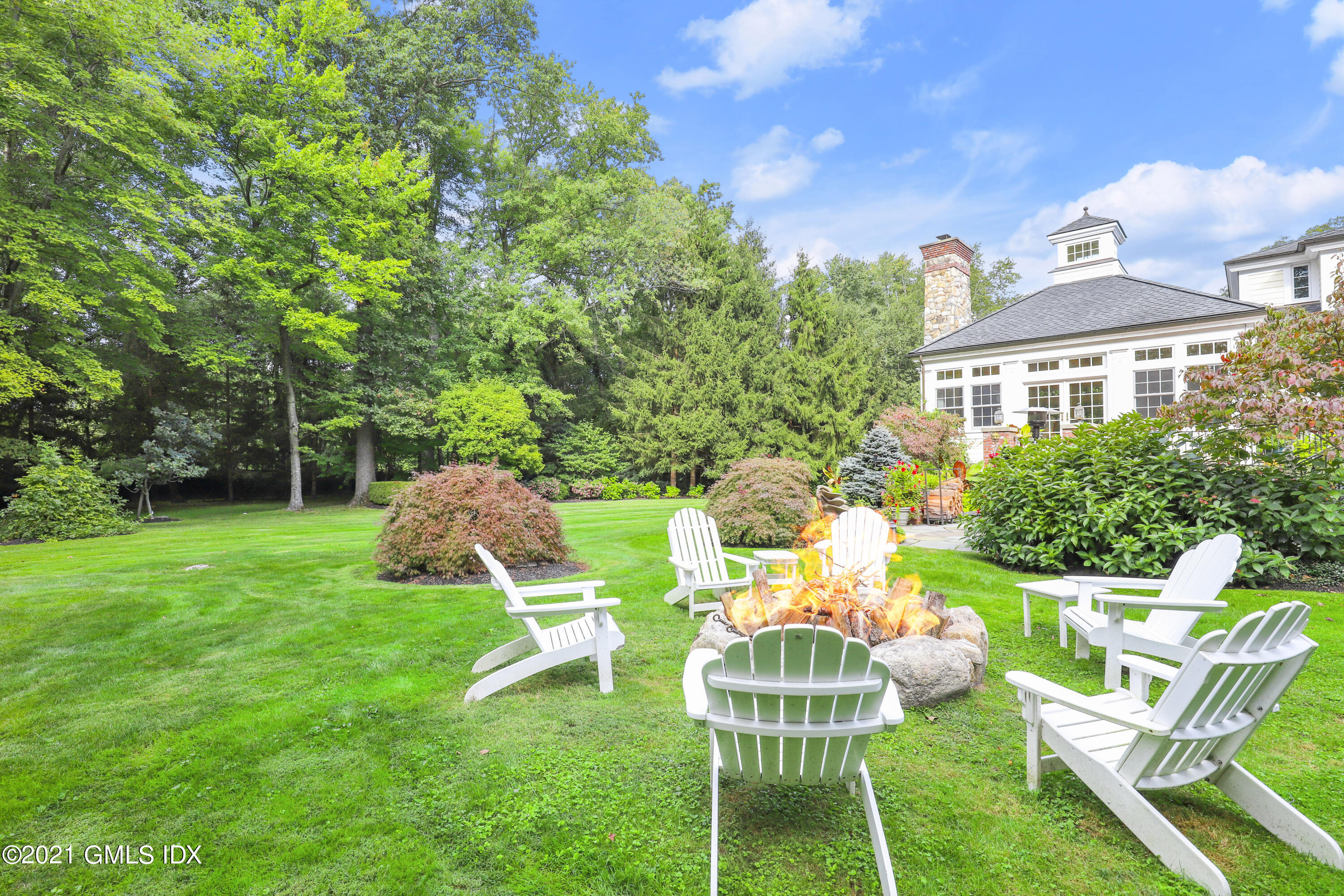 5 Tinker Lane Greenwich, CT 06830 - Photo 38 of 44 a view of a chair and table in backyard of the house