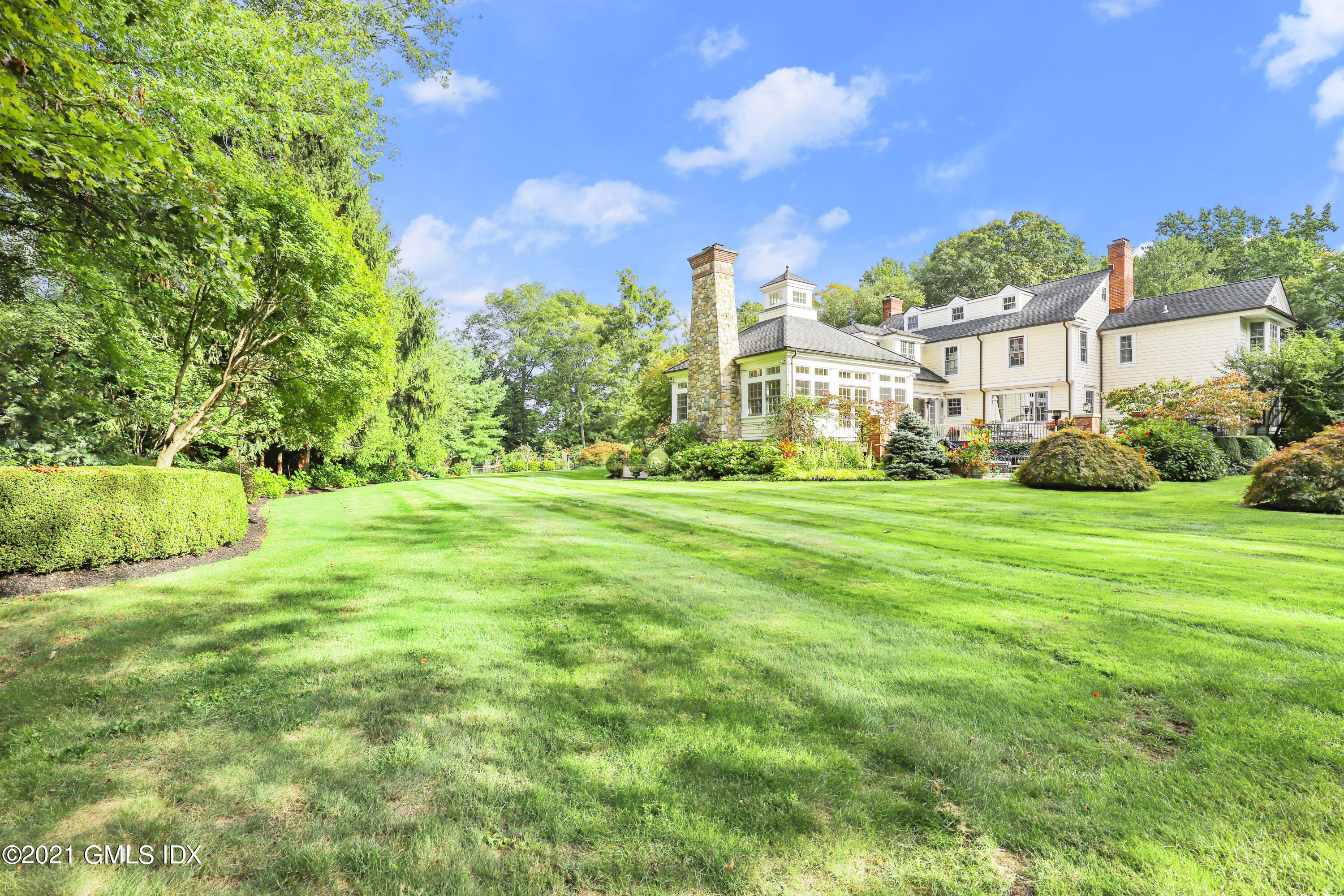 5 Tinker Lane Greenwich, CT 06830 - Photo 4 of 44 a view of a big yard with a house in the background