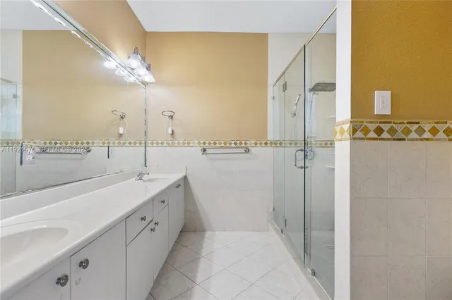 a bathroom with a double vanity sink and mirror