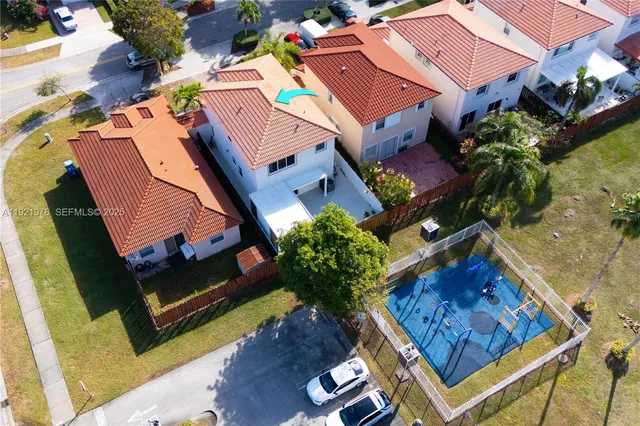 an aerial view of a house with swimming pool and porch