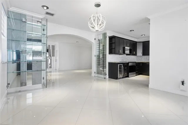 a view of kitchen with stainless steel appliances kitchen island granite countertop a refrigerator and a sink