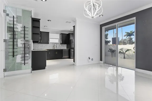 a kitchen with stainless steel appliances kitchen island granite countertop a refrigerator and a sink