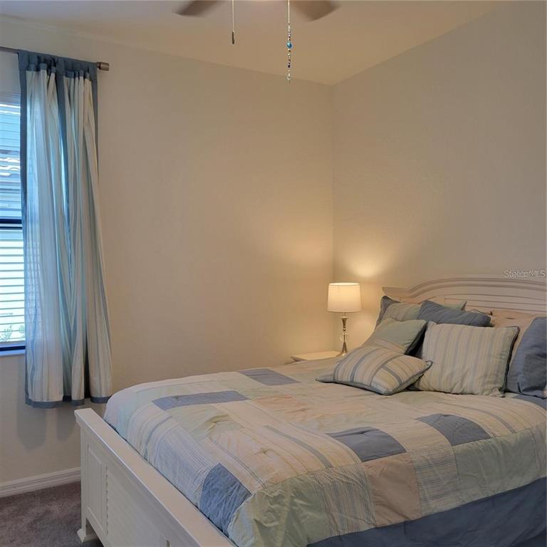 17335 Blue Ridge Place Bradenton, FL 34211 - Photo 13 of 44 a bedroom with a bed and a window