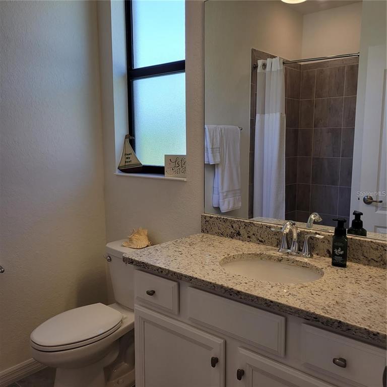 17335 Blue Ridge Place Bradenton, FL 34211 - Photo 15 of 44 a bathroom with a granite countertop toilet sink and mirror