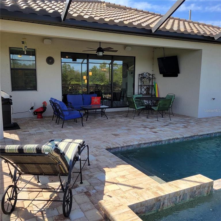 17335 Blue Ridge Place Bradenton, FL 34211 - Photo 21 of 44 a view of a patio with table and chairs with wooden floor and fence
