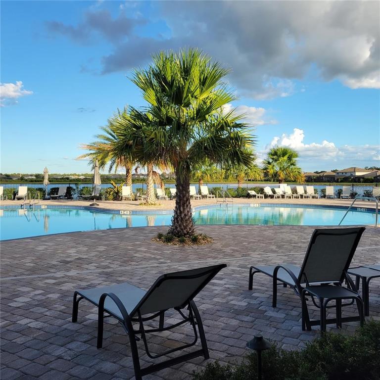 17335 Blue Ridge Place Bradenton, FL 34211 - Photo 32 of 44 a view of a lake with table and chairs in patio