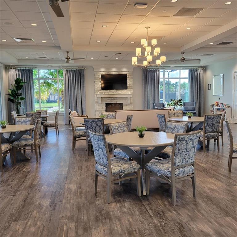 17335 Blue Ridge Place Bradenton, FL 34211 - Photo 33 of 44 a view of a dining room with furniture a chandelier and wooden floor