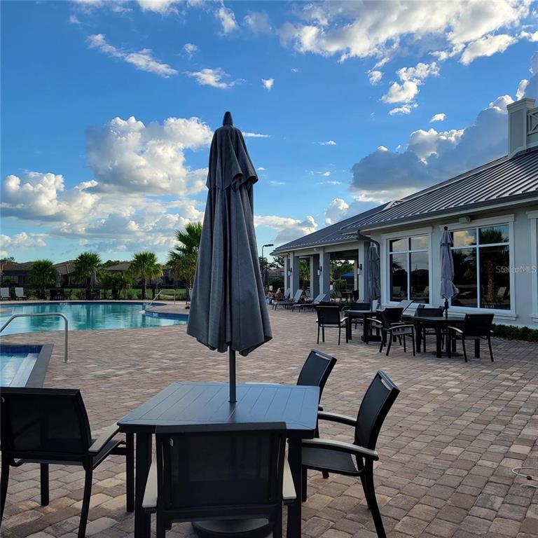 17335 Blue Ridge Place Bradenton, FL 34211 - Photo 34 of 44 a view of a dinning table and chairs in patio