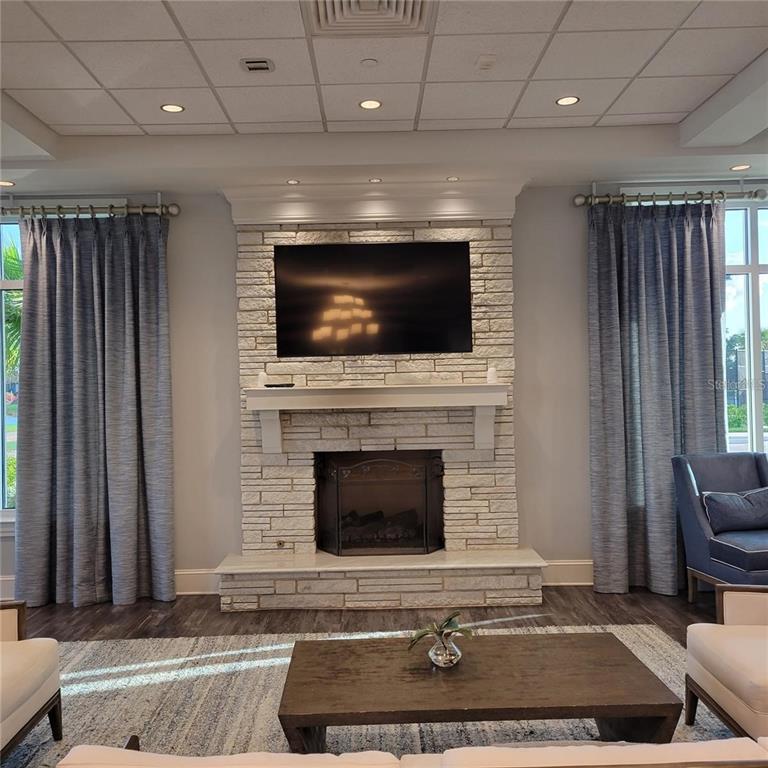 17335 Blue Ridge Place Bradenton, FL 34211 - Photo 36 of 44 a living room with fireplace furniture and a flat screen tv