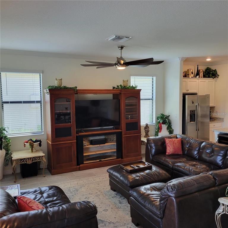 17335 Blue Ridge Place Bradenton, FL 34211 - Photo 8 of 44 a living room with furniture and a flat screen tv