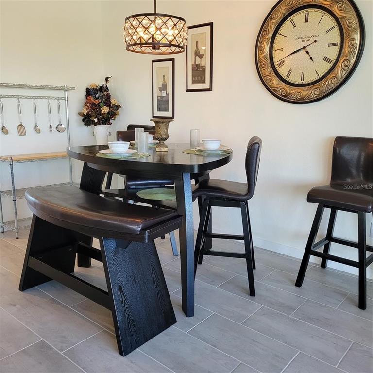 17335 Blue Ridge Place Bradenton, FL 34211 - Photo 9 of 44 a view of a dining room with furniture and a chandelier