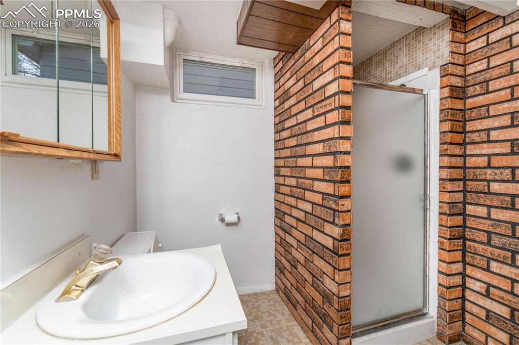 2818 Templeton Gap Road Colorado Springs, CO 80907 - Photo 15 of 27 a bathroom with a sink and a mirror