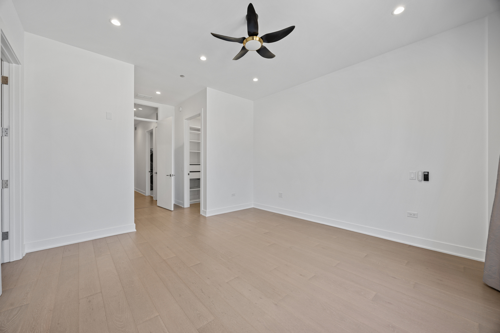 305 South Racine Avenue, Unit PHD Chicago, IL 60607 - Photo 23 of 49 wooden floor in an empty room with a ceiling fan