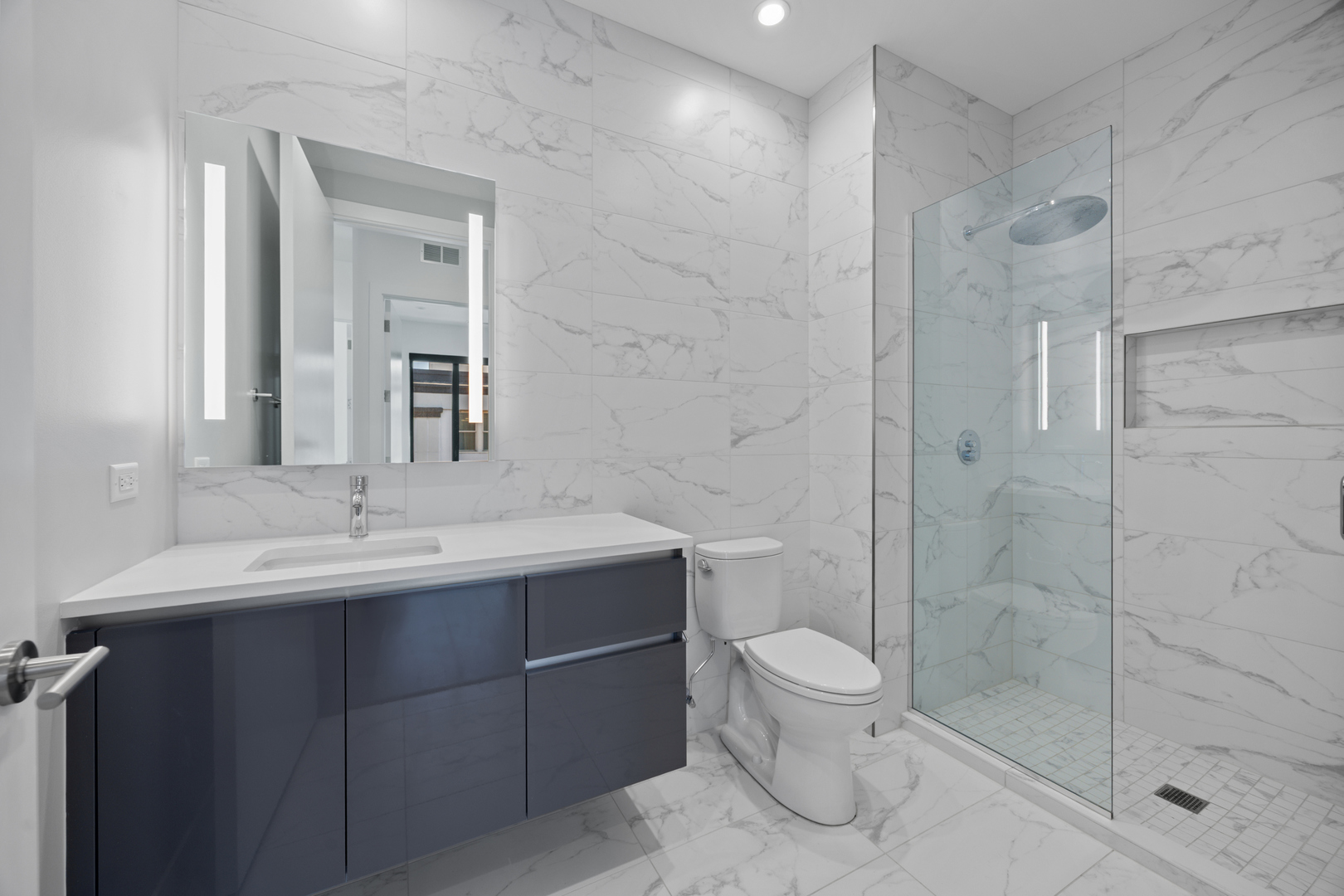 305 South Racine Avenue, Unit PHD Chicago, IL 60607 - Photo 33 of 49 a bathroom with a toilet a sink a mirror and shower