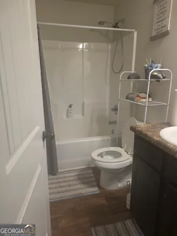 a bathroom with a toilet and a shower