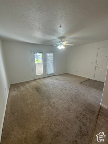 8196 North Cedar Springs Road, Unit 2 Eagle Mountain, UT 84005 - Photo 9 of 22 Carpeted spare room with baseboards and a textured ceiling