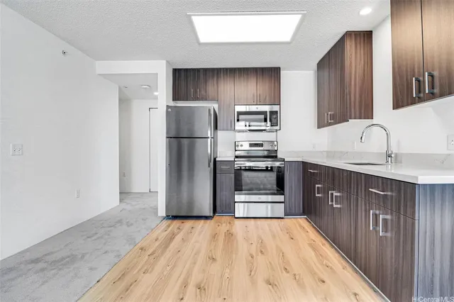 a kitchen with stainless steel appliances a refrigerator and a sink