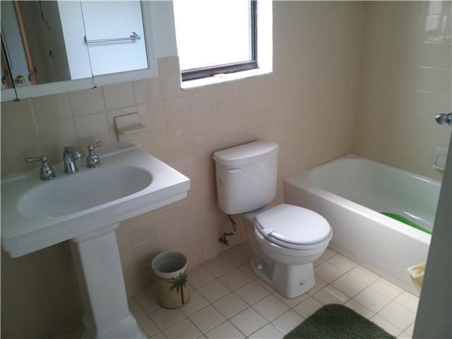 417 Apache Lane Boca Raton, FL 33487 - Photo 4 of 13 a white toilet sitting next to a bathroom sink