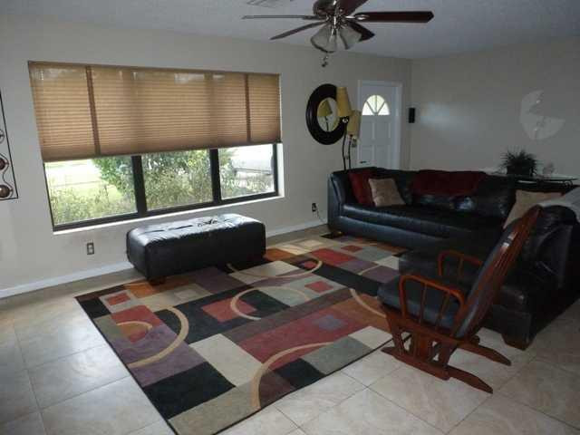 417 Apache Lane Boca Raton, FL 33487 - Photo 5 of 13 a living room with a couch a window and a fireplace